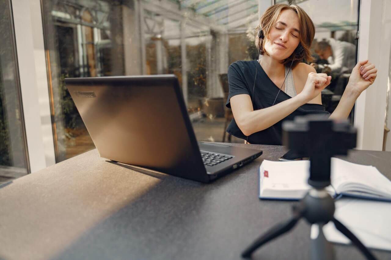 Office fun, a woman dancing during work, computer, notebook